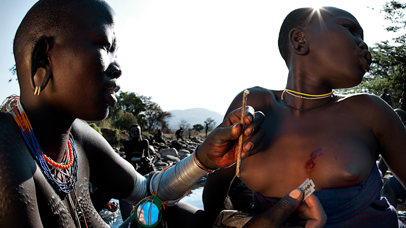 Women perform scarification.