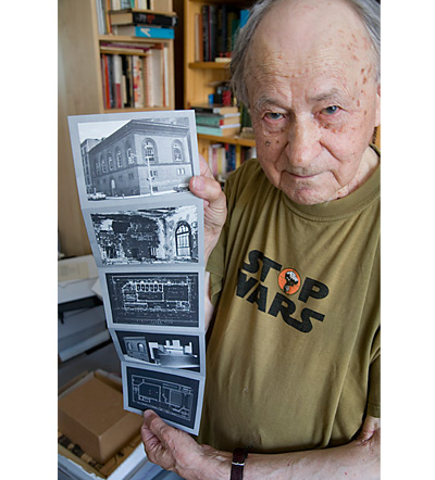 Jonas holding up a postcard series of the derelict building he bought from the city of New York over 40 years ago and transformed into the Anthology Film Archives. Photography by Derek Peck