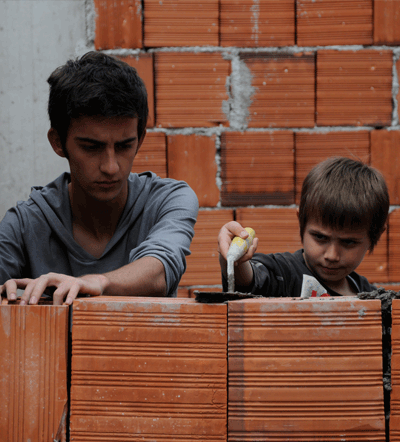 Nik (Tristan Halilaj) and his best friend Tom (Erjon Mani) hangout  after school in Joshua Marston's THE FORGIVENESS OF BLOOD. Photo credit Anila Jaho. A Sundance Selects release.