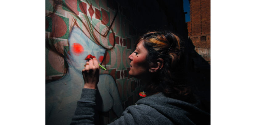 Miss Van painting in Raval, Barcelona, 2009.