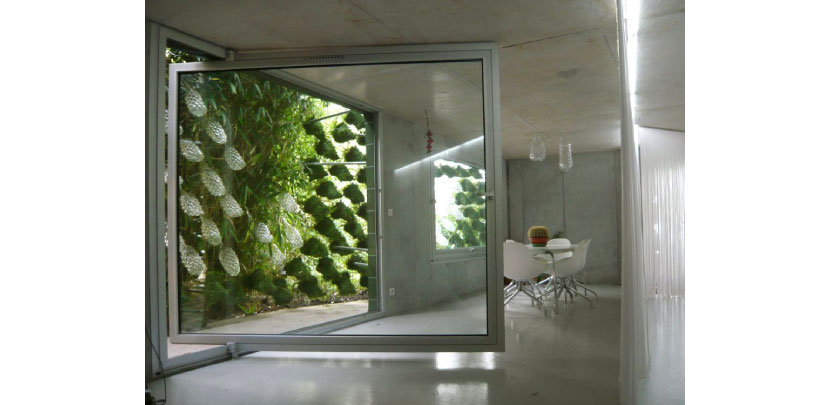 I'mlostinparis, facade with suspended glass vessels at a house in Paris.