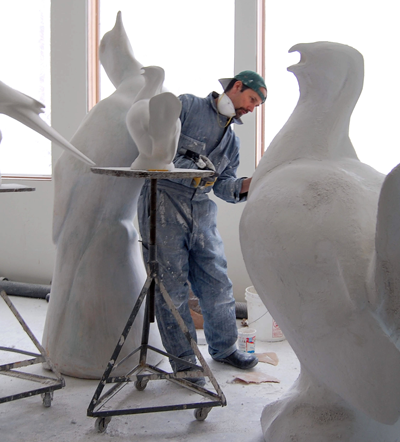 A plaster mold of a Carolina Parakeet sits on a stand in artist Todd McGrain's studio near Ovid, New York. from <em>The Lost Bird Project</em>