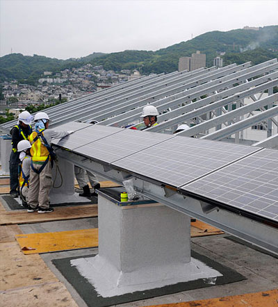 Japanese workers install solar panels, 2010/Richard Doolin, U.S. Navy